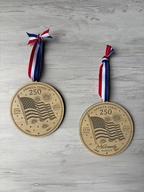 Wooden Ornament with waving American flag and fireworks celebrating America's 250th birthday
