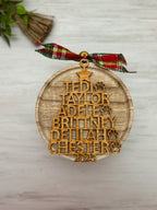 Stacked family names in a Christmas tree shape with paw prints denoting pets.