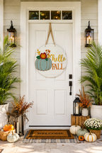 A round wooden 'hello fall' door hanging displayed on a white front door. 