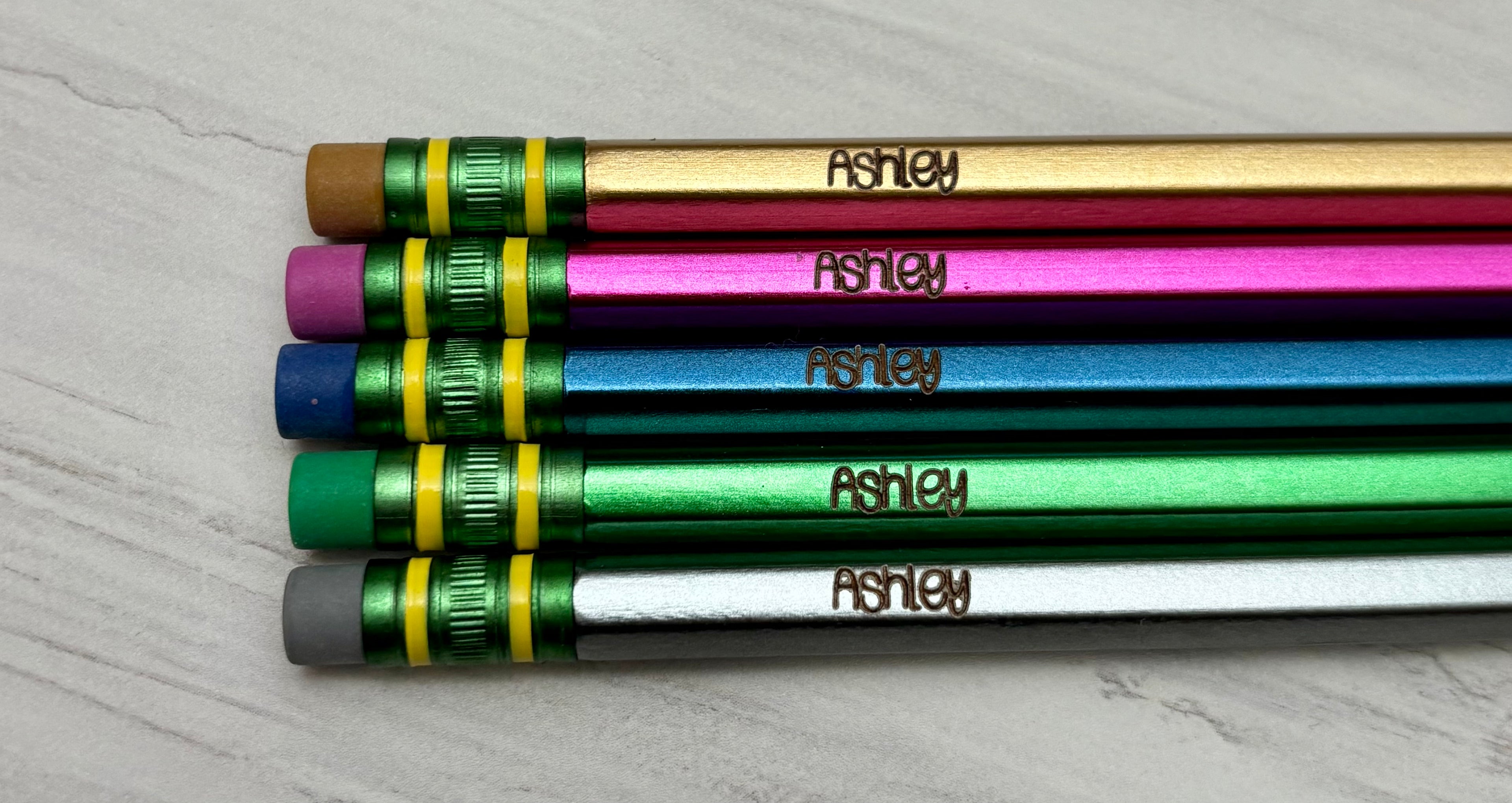 Five personalized metallic pencils customized with a name