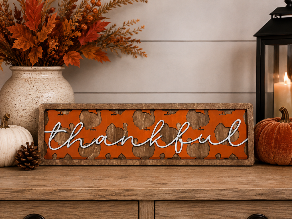 A rectangular decorative sign with the word 'thankful' in white script over an orange turkey background.