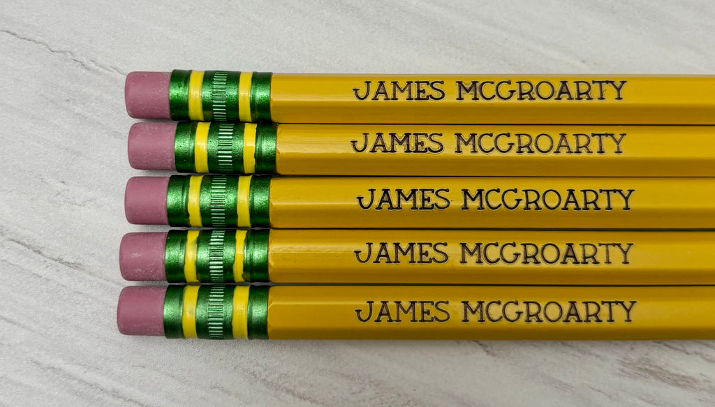 Five personalized yellow pencils that are engraved.